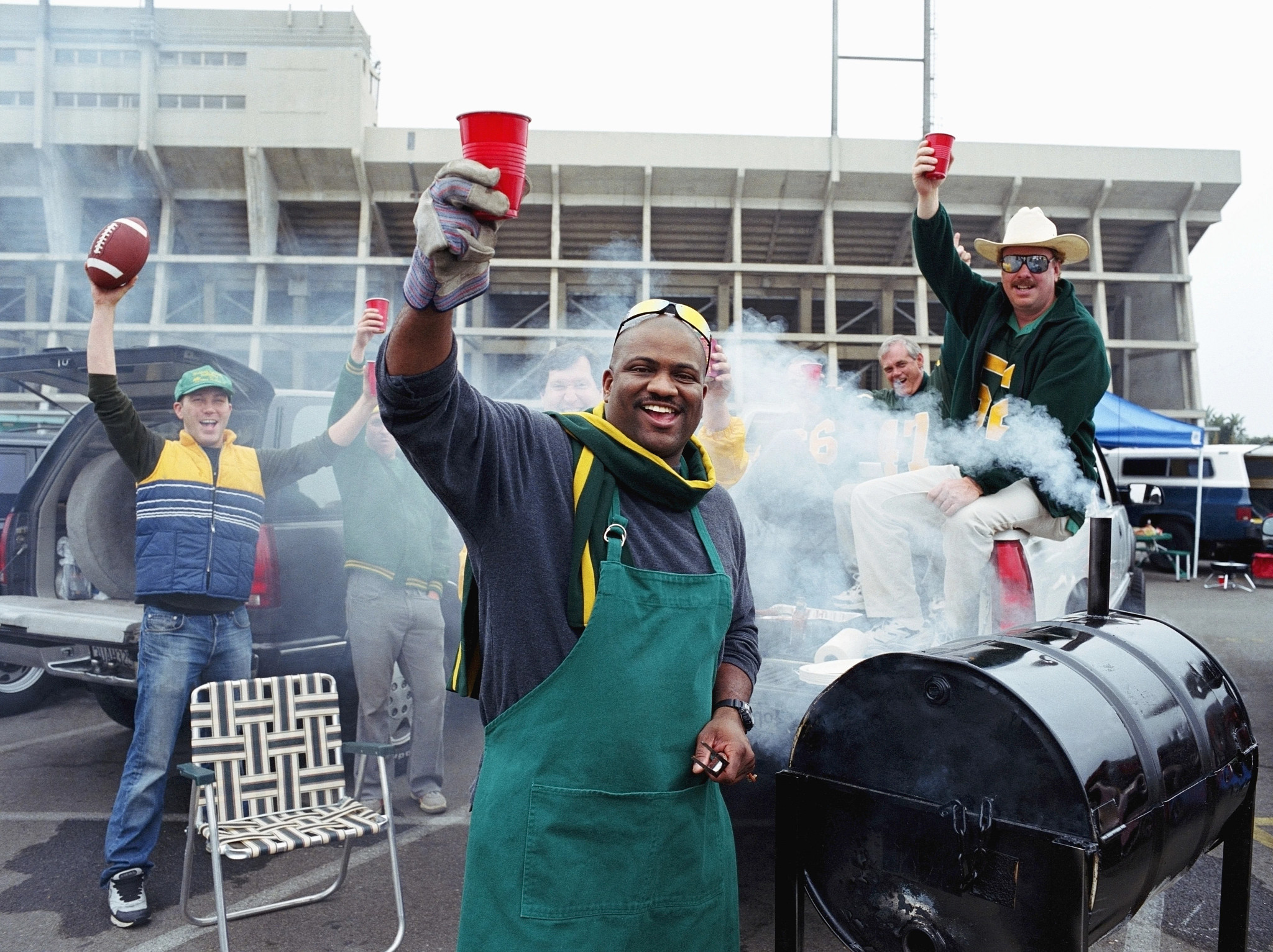 a photo shows tailgaters carrying the party outside the stadium after the game