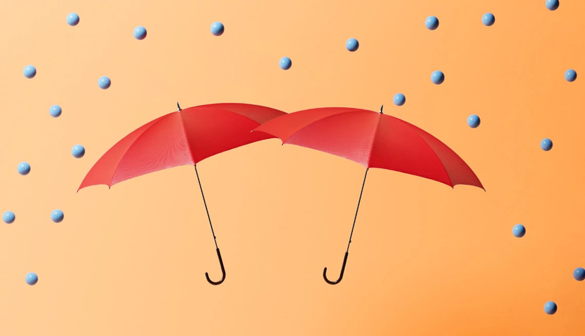 illustration of two red umbrellas with blue colored balls raining on them