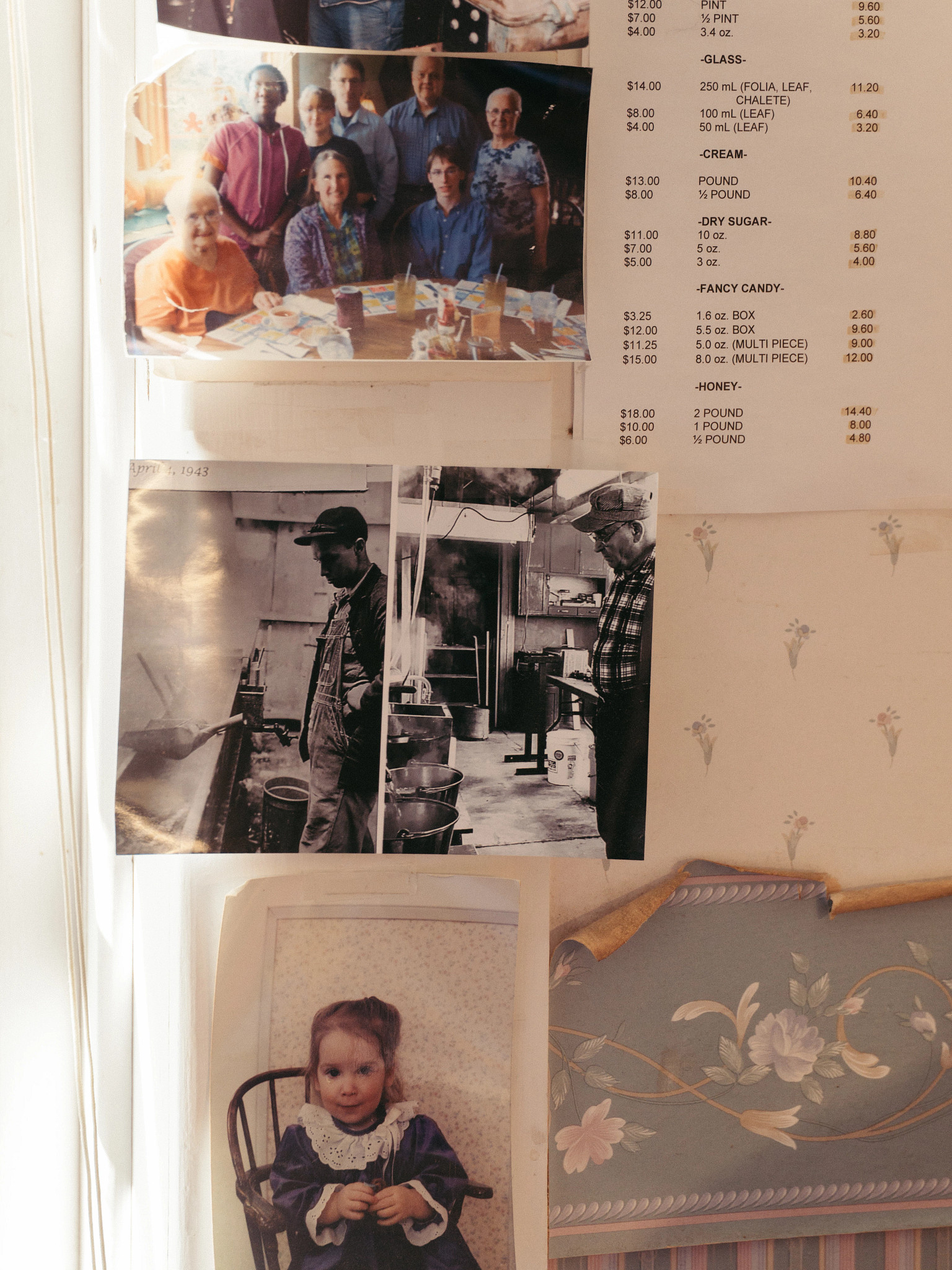 A wall display featuring family photographs and vintage black-and-white images