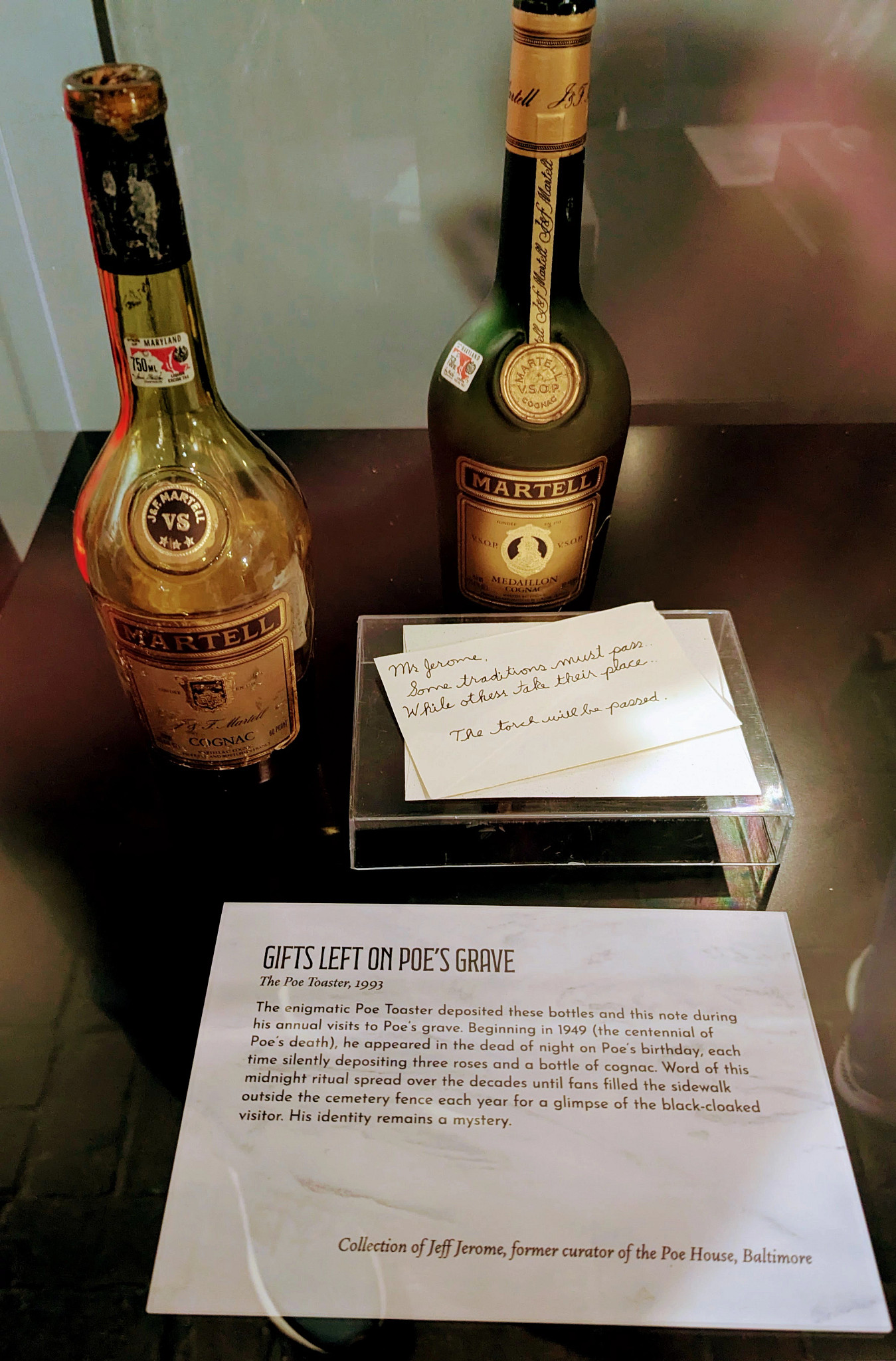 Bottles of cognac and a note that a mysterious visitor left on Poe's grave in Baltimore to mark his birthday.