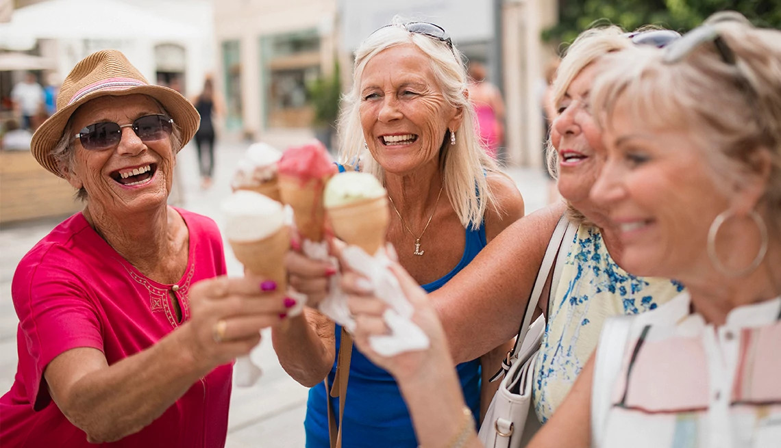 AARP members enjoying ice cream on a summer day, linking to AARP Rewards