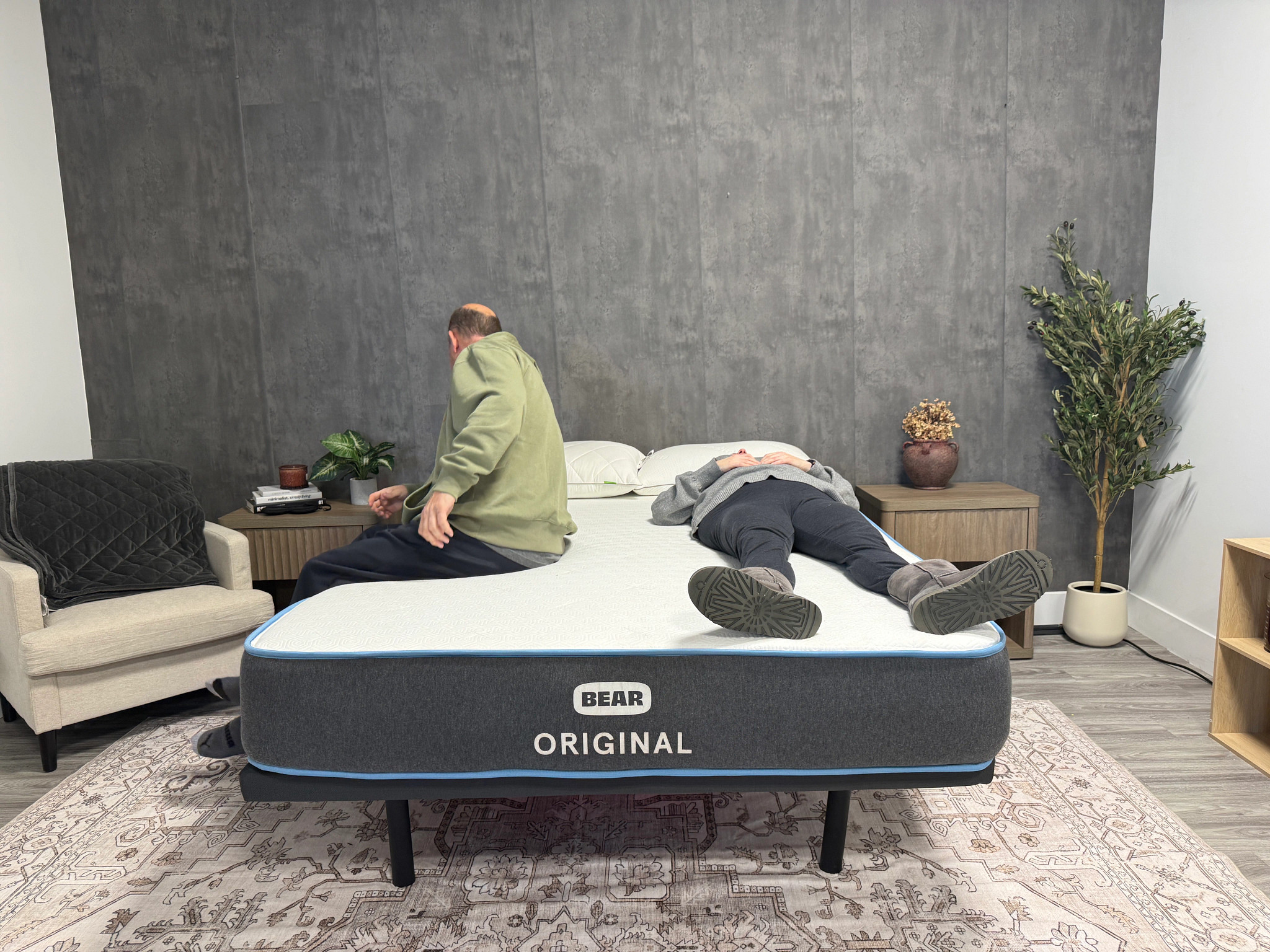 Man and woman lie on opposite sides of a mattress