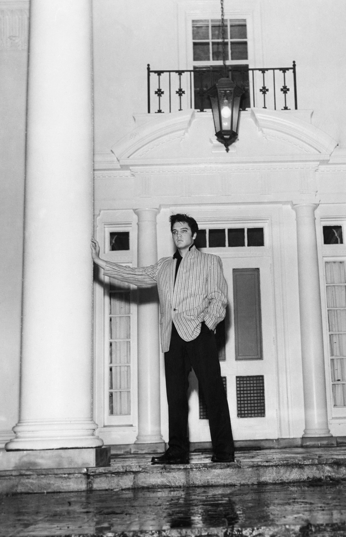Elvis Presley standing on a porch