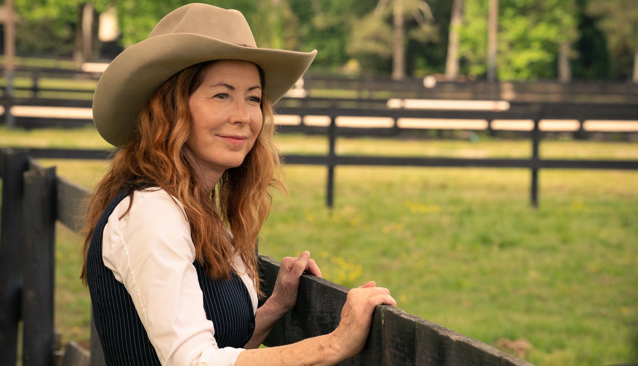 Dana Delany stars in 'Tulsa King' Dana Delany as Margaret Devereaux wearing cowboy hat outside in a still from Tulsa King