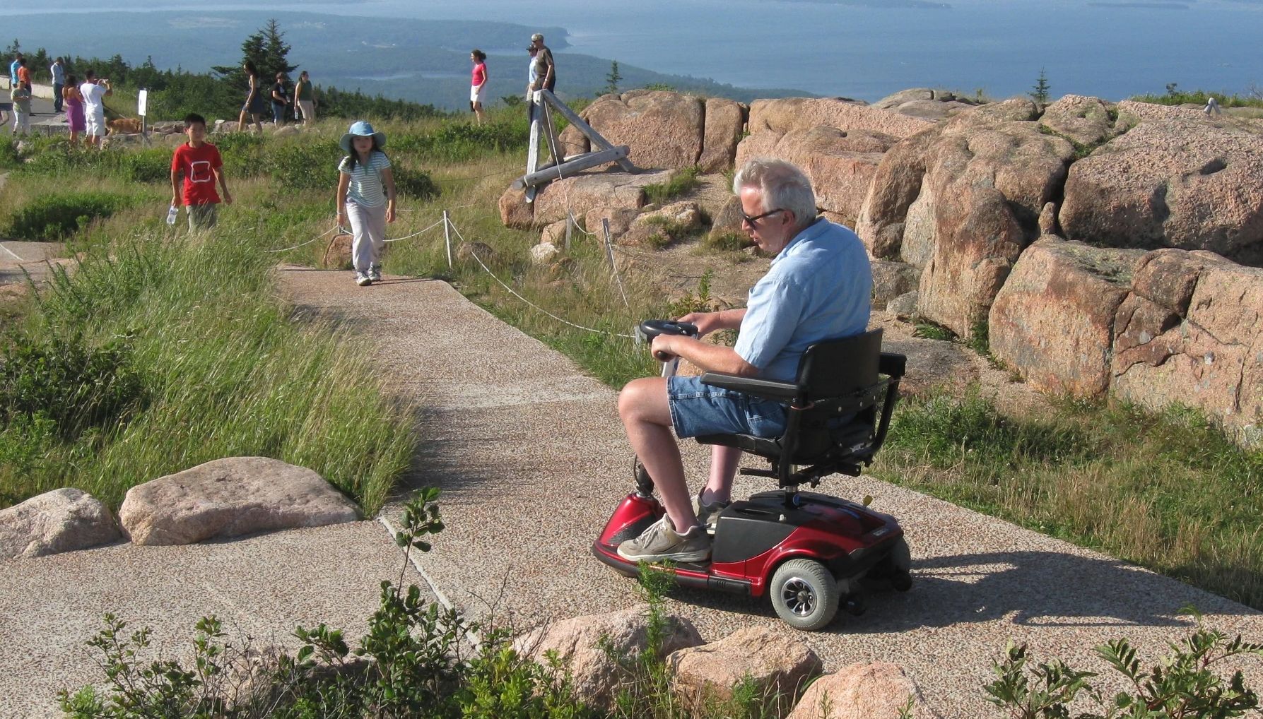 an accessible pathway at Acadia National Park a man in a wheelchair along the Cadillac accessible path at Acadia National Park