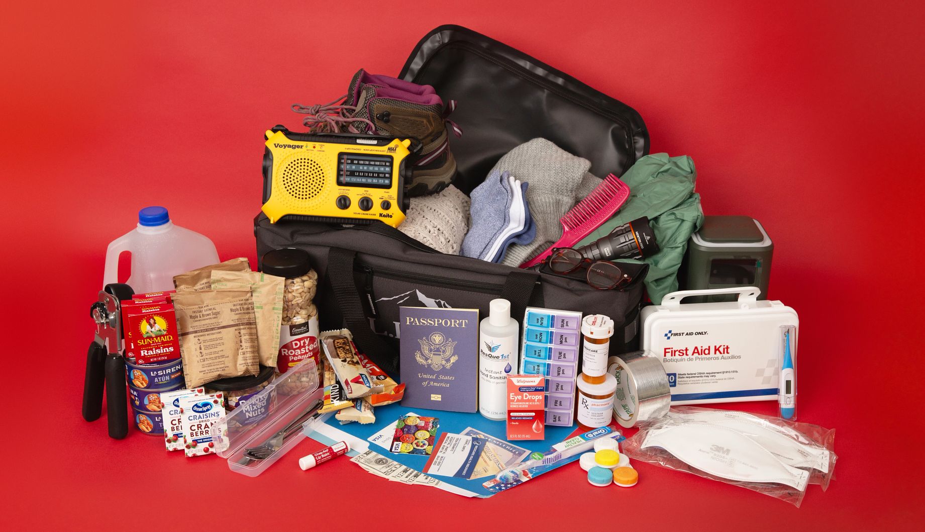 Essential Items for an Emergency Go Bag a duffel bag filled with emergency kit contents, including medicine, personal identification, food and more