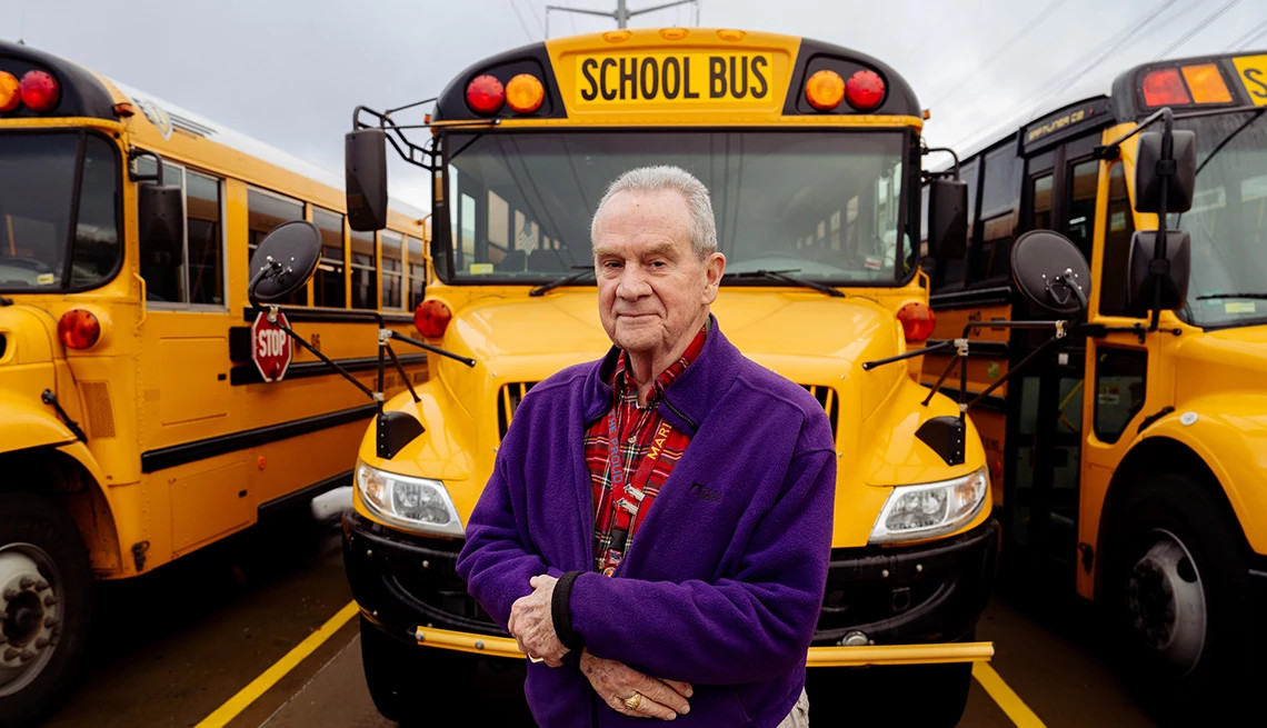 a man standing in front of a bus