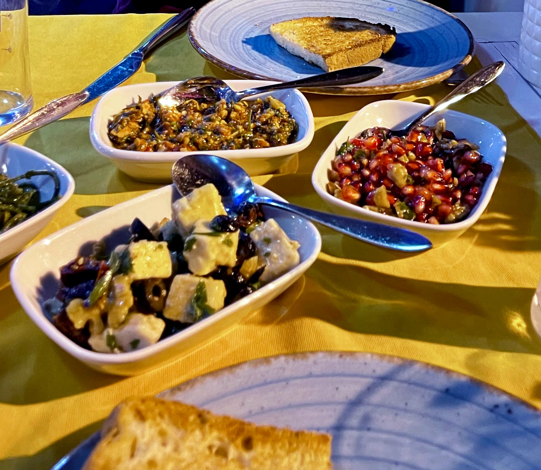 Tips for Dining Alone food in white dishes on top of a yellow tablecloth