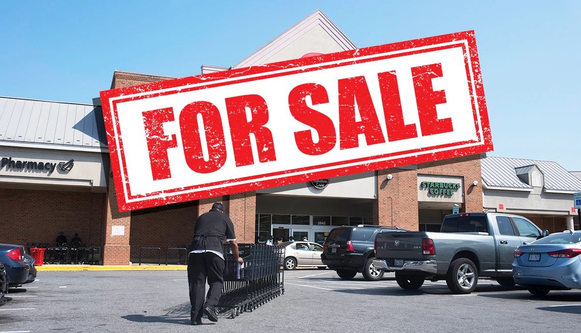supermarkets closing a for sale sign over a store