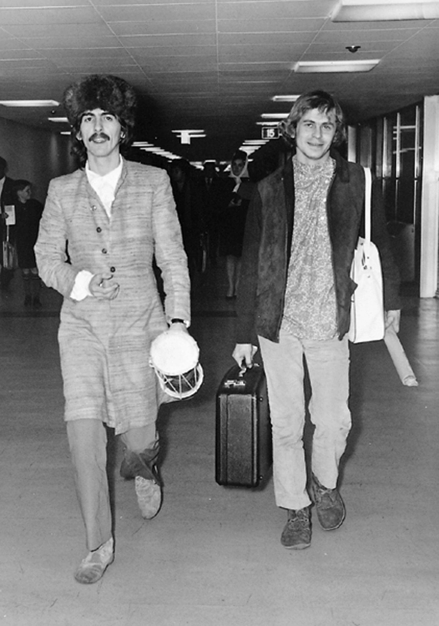 George Harrison and Alex Mardas arriving at London Airport
