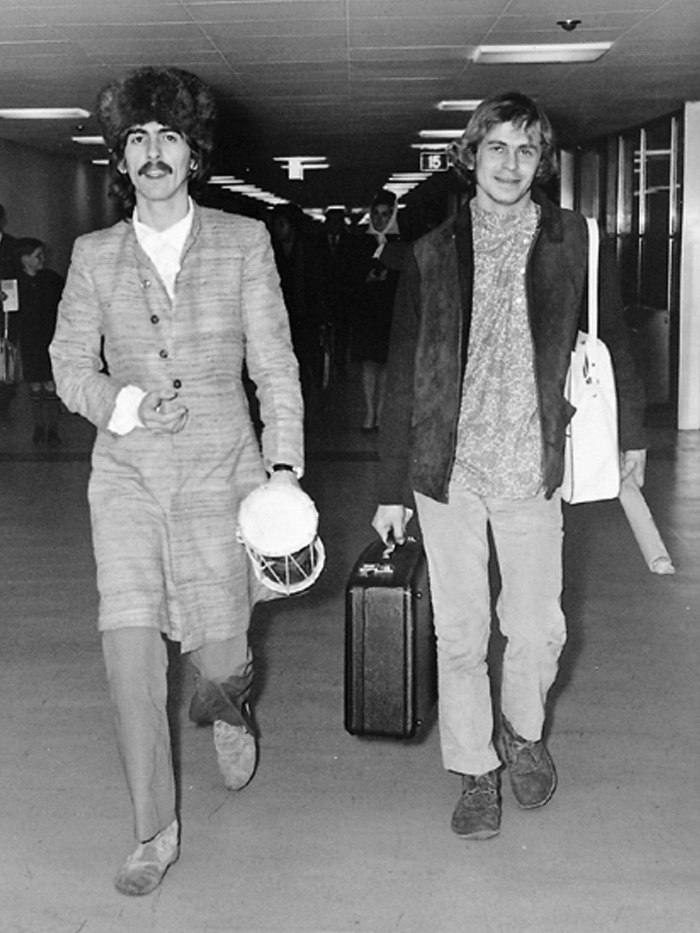 George Harrison and Alex Mardas arriving at London Airport