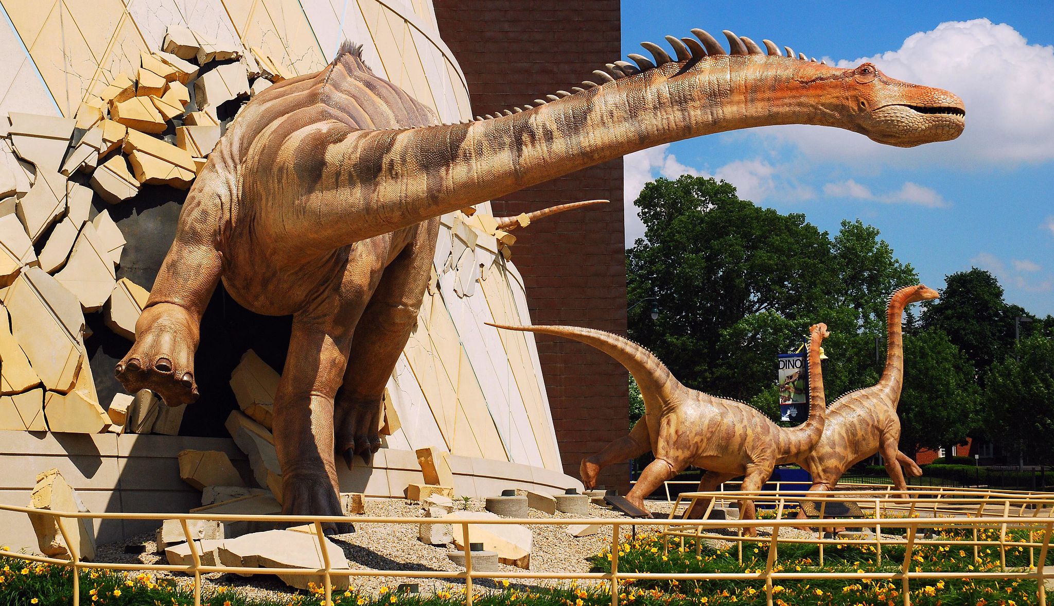 Grandkids will love seeing dinosaurs at the Indianapolis Children's Museum A group of dinosaurs appear to break out of the facade of the Indianapolis Children's Museum