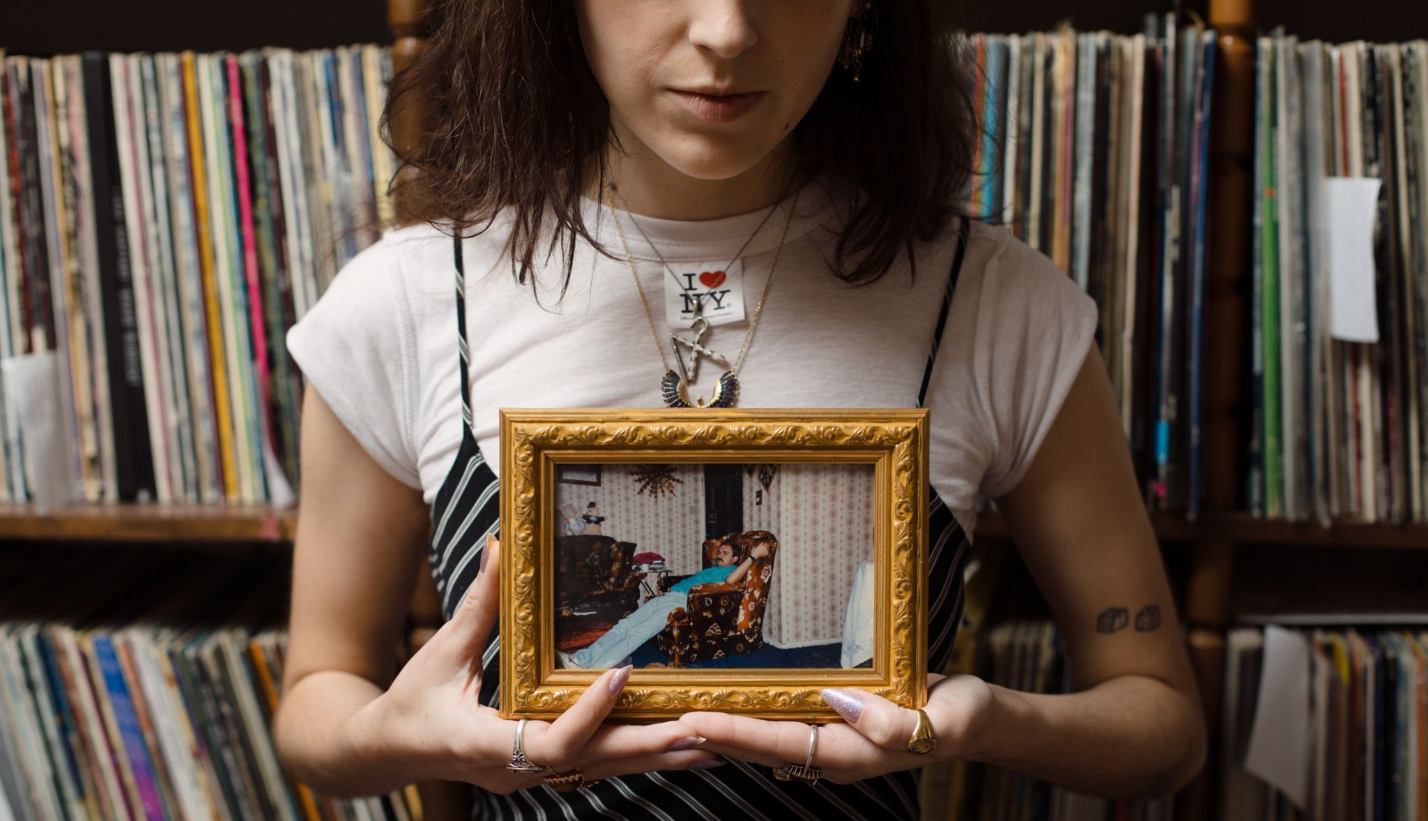 My Dad Lives On, Through the Record Albums He Left Behind a woman holding a picture frame