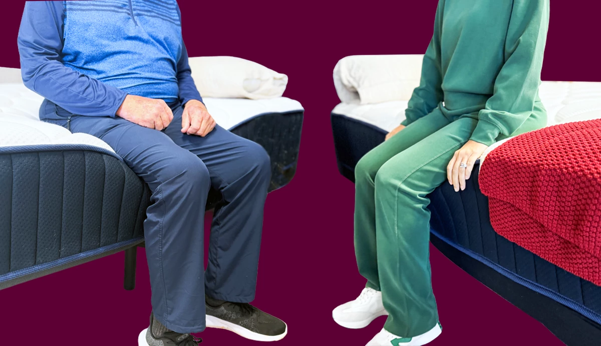 Two people sitting on the edge of separate mattresses facing one another