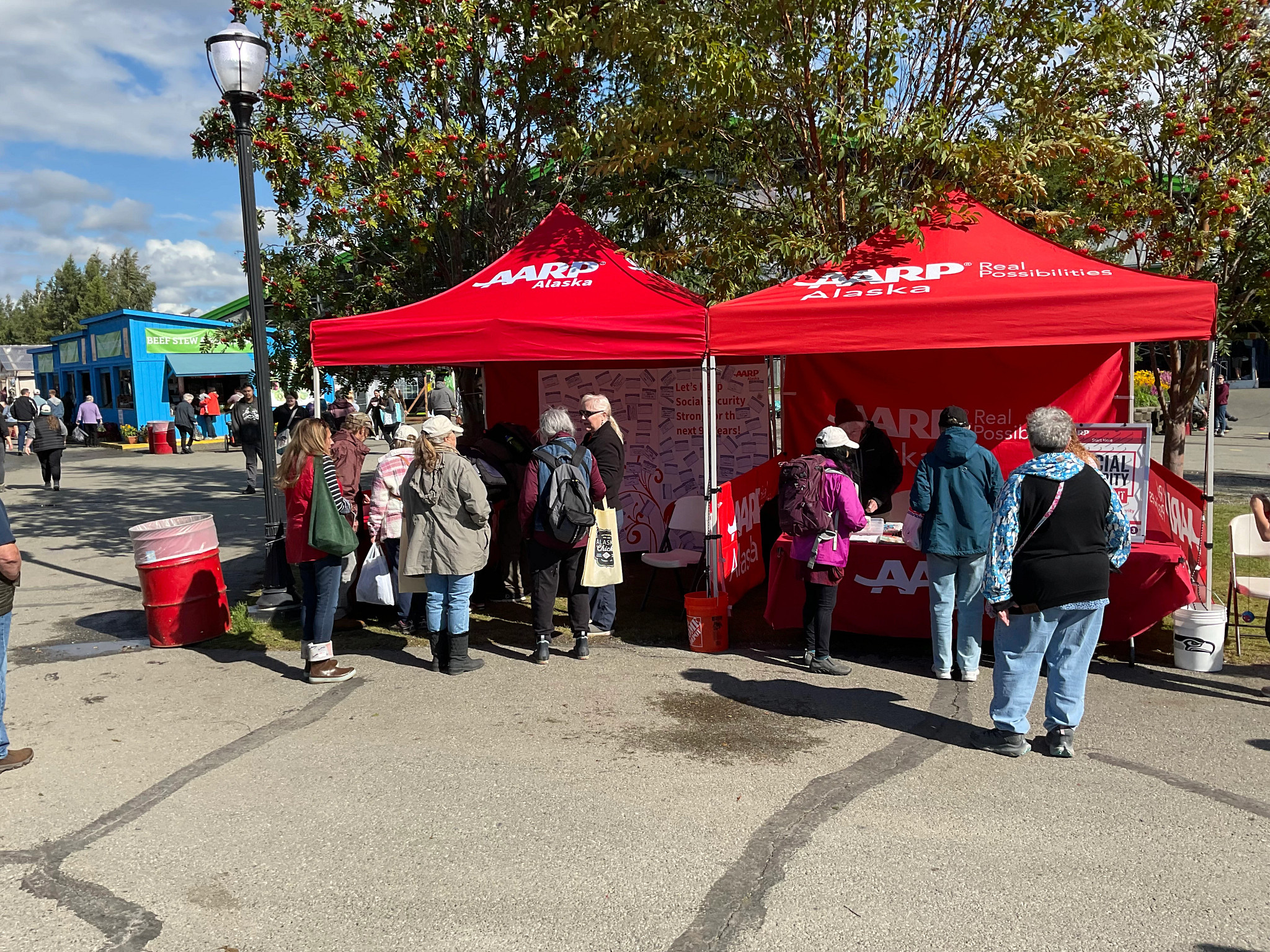Volunteers and fair attendees discuss Social Security