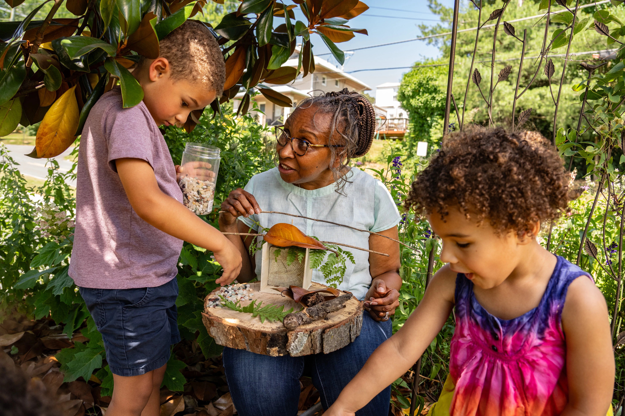 Melinda helps her granddaughter Adele add a chair for their fairy garden