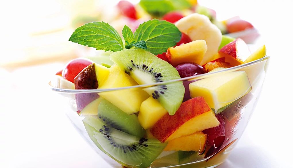 Trade in chips and pretzels for colorful fruits and vegetables A close up of a bowl of fruit salad
