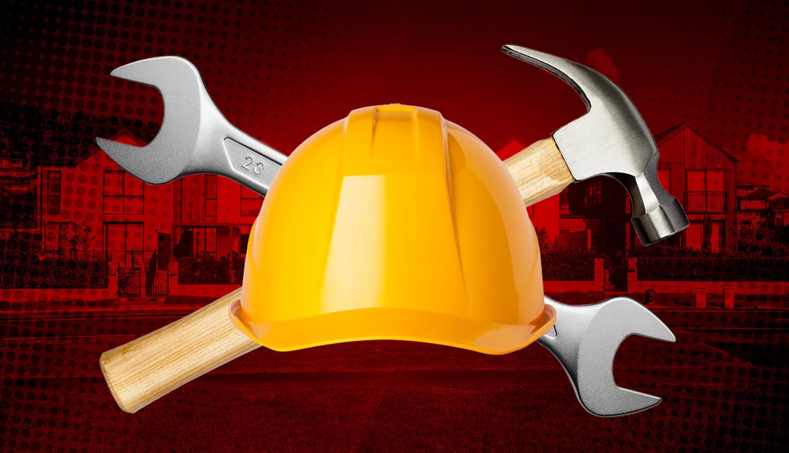 The shadow of a hand holding a wrench is hovering over a cracked home image on a purple background.