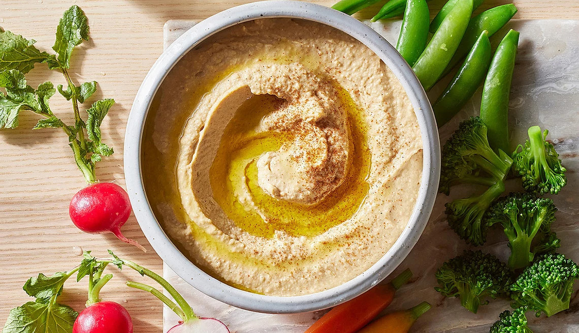 A close-up view of garlic hummus in a bowl