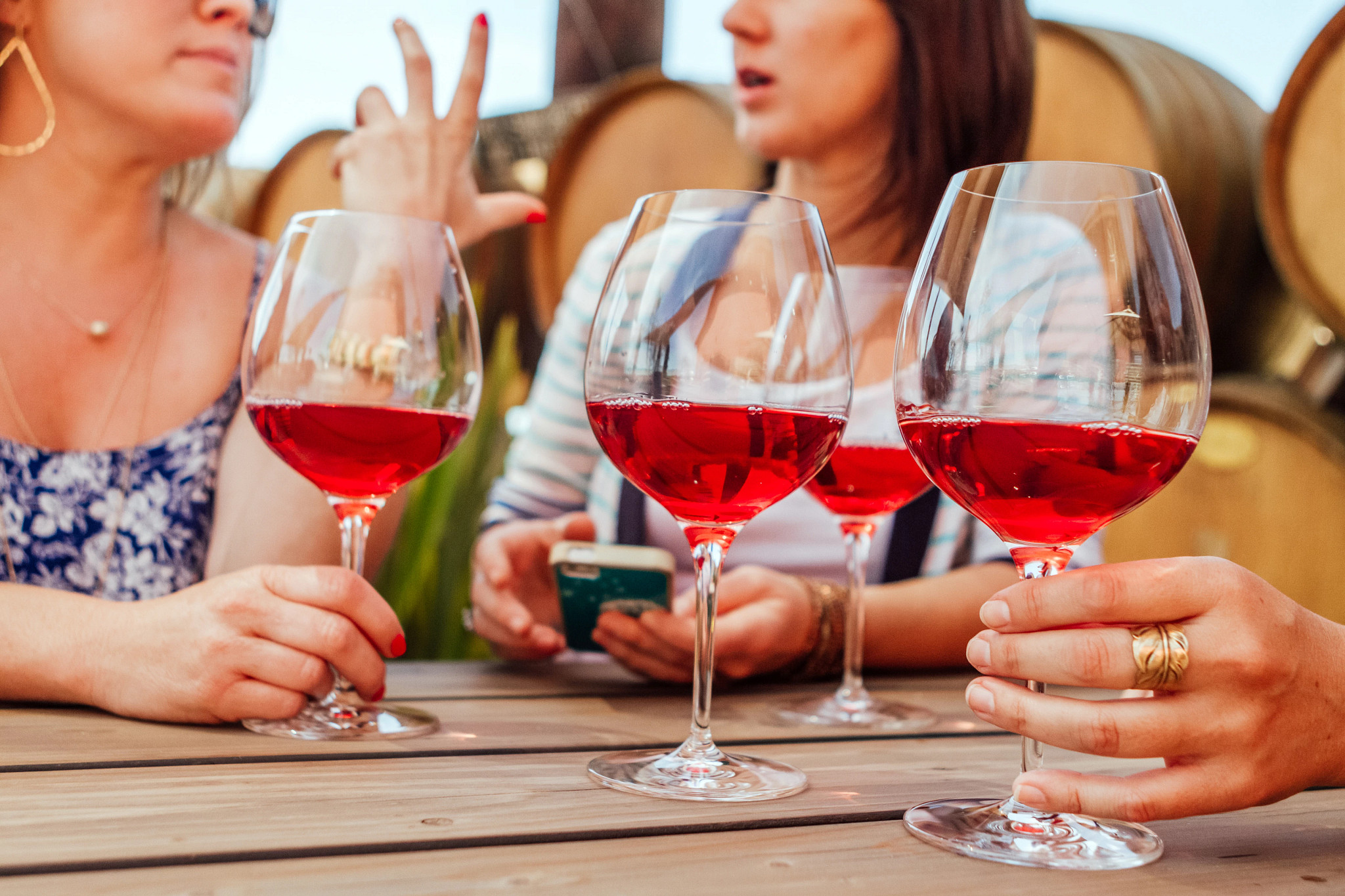 Women Talking And Drinking Rose Wine