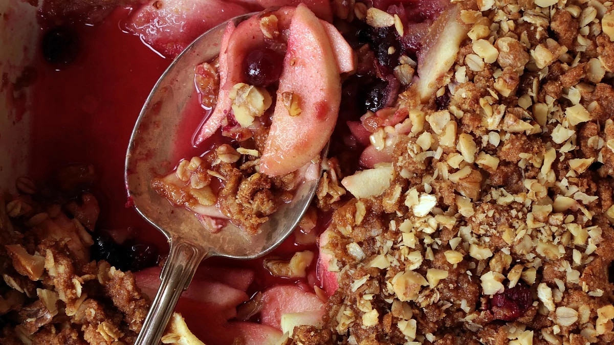 A close-up view of apple-cranberry crisp in a spoon