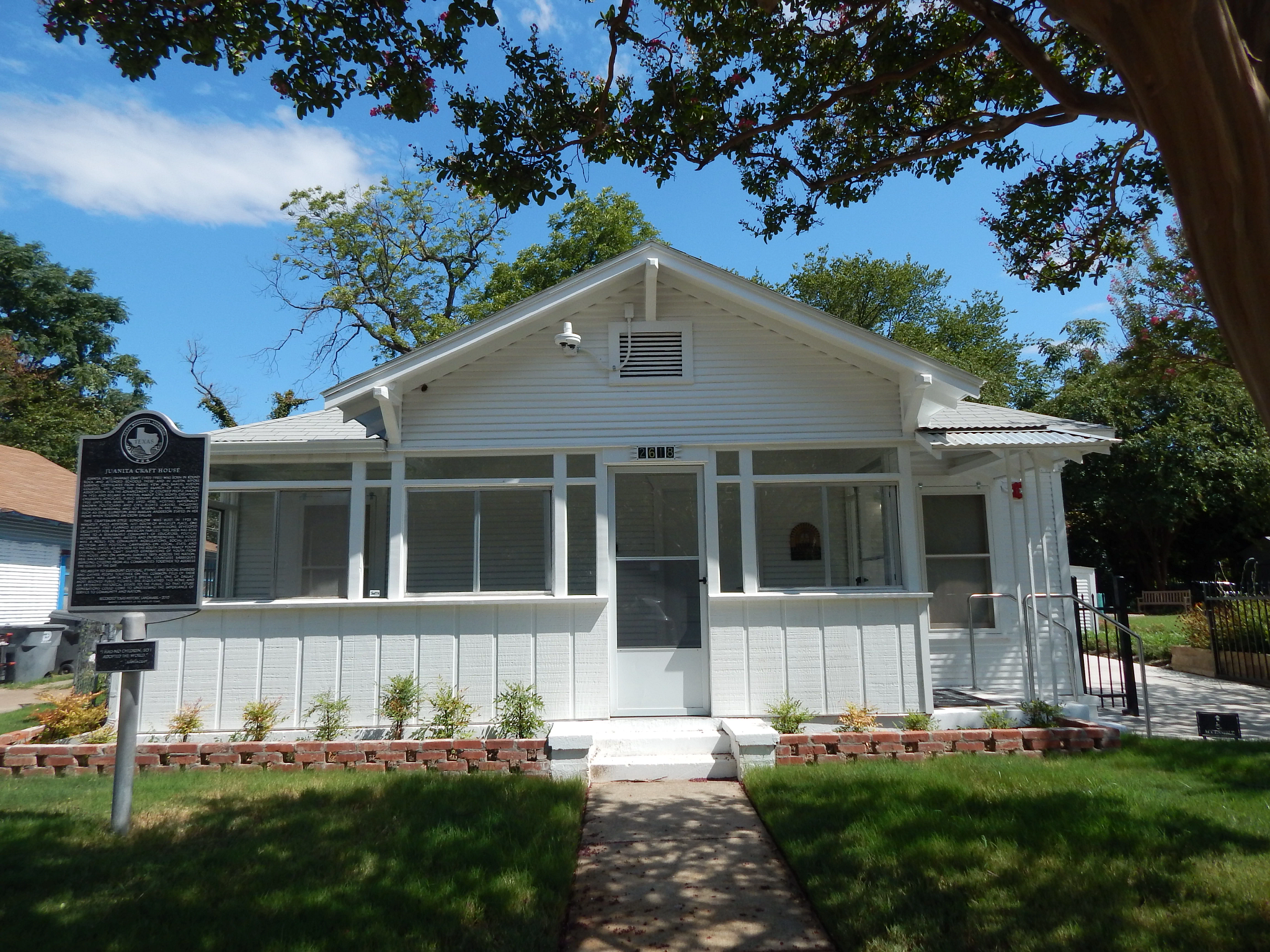 a white house with a historical marker