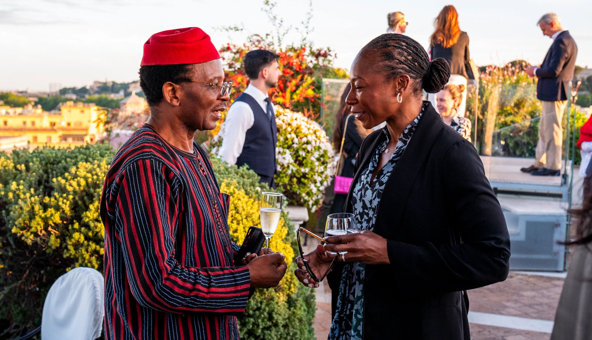 Dr. Myechia Minter-Jordan and Alfred K. Njamnshi two people in the middle of a discussion at an outside event