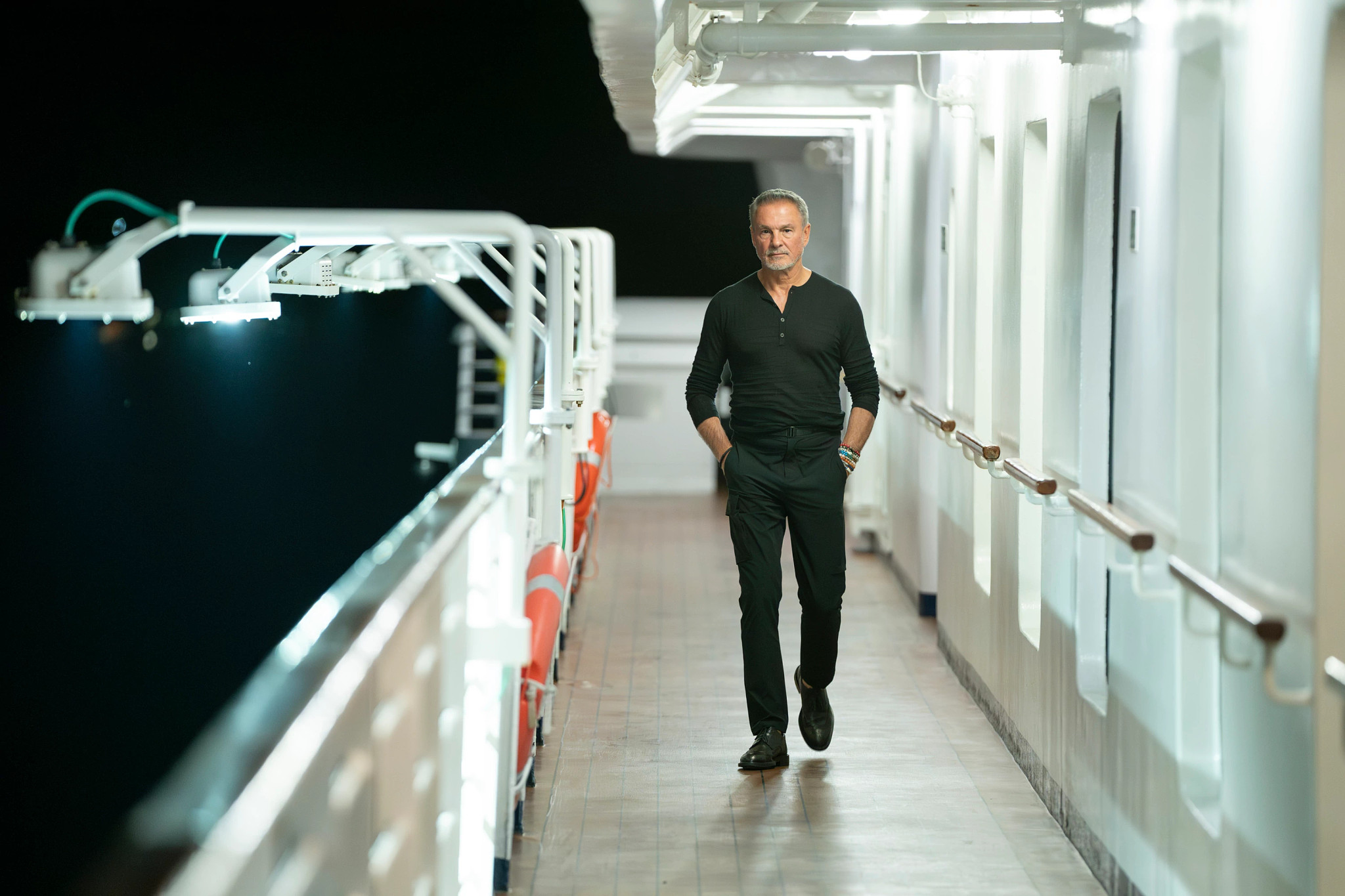 a man walking on the deck of a boat