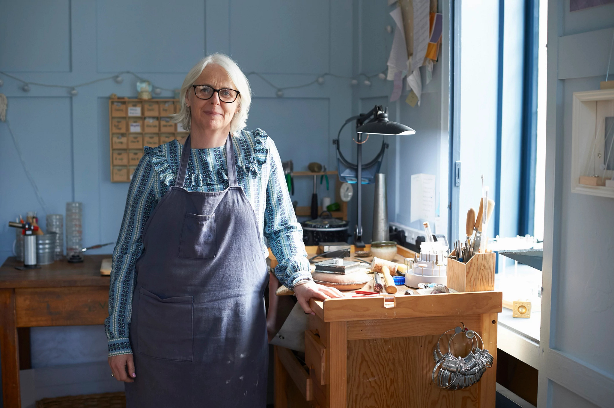 female jeweler at work table