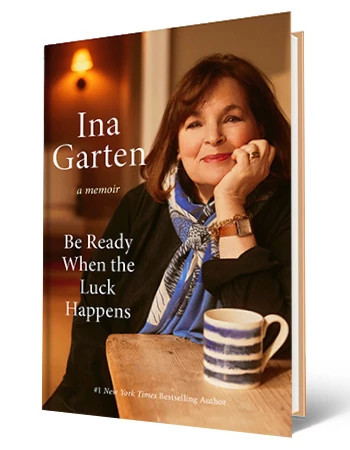 Book cover that says Ina Garten, A Memoir, Be Ready When the Luck Happens; picture of Ina Garten sitting at table on cover