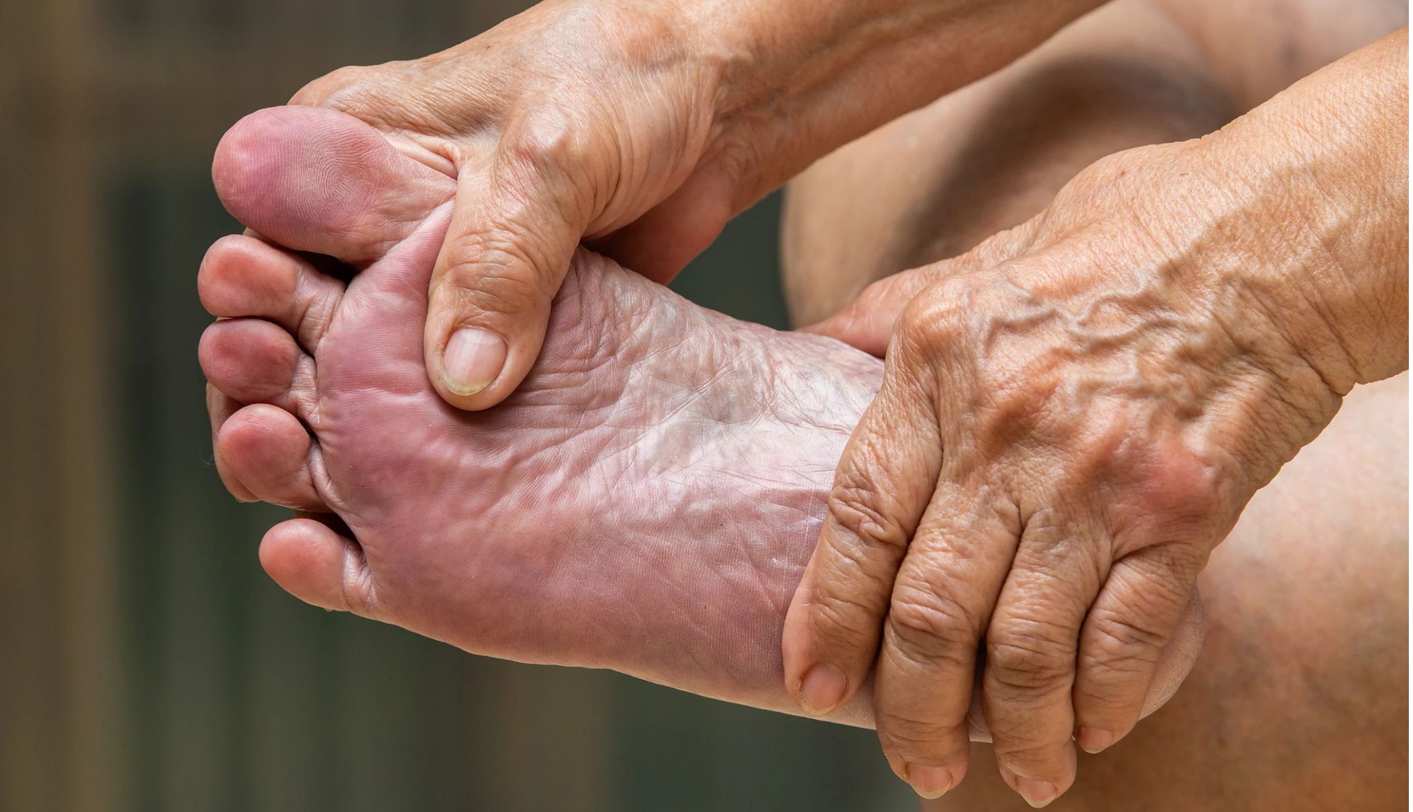 Foot Pain You Shouldn't Ignore person grabbing their foot in pain