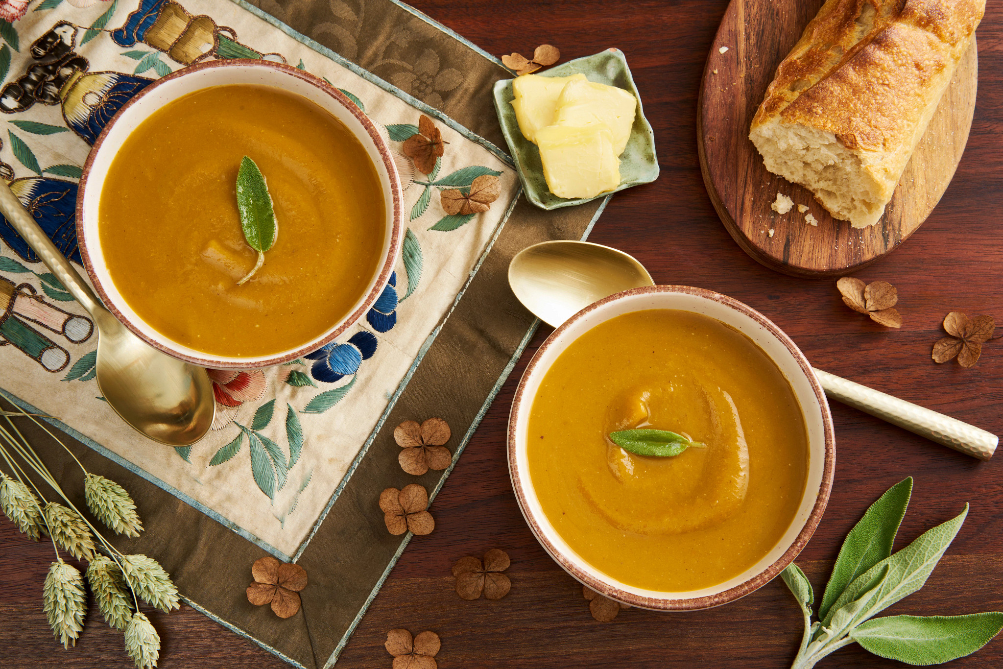 Squash and Chestnut Soup from above on a wood table with decore