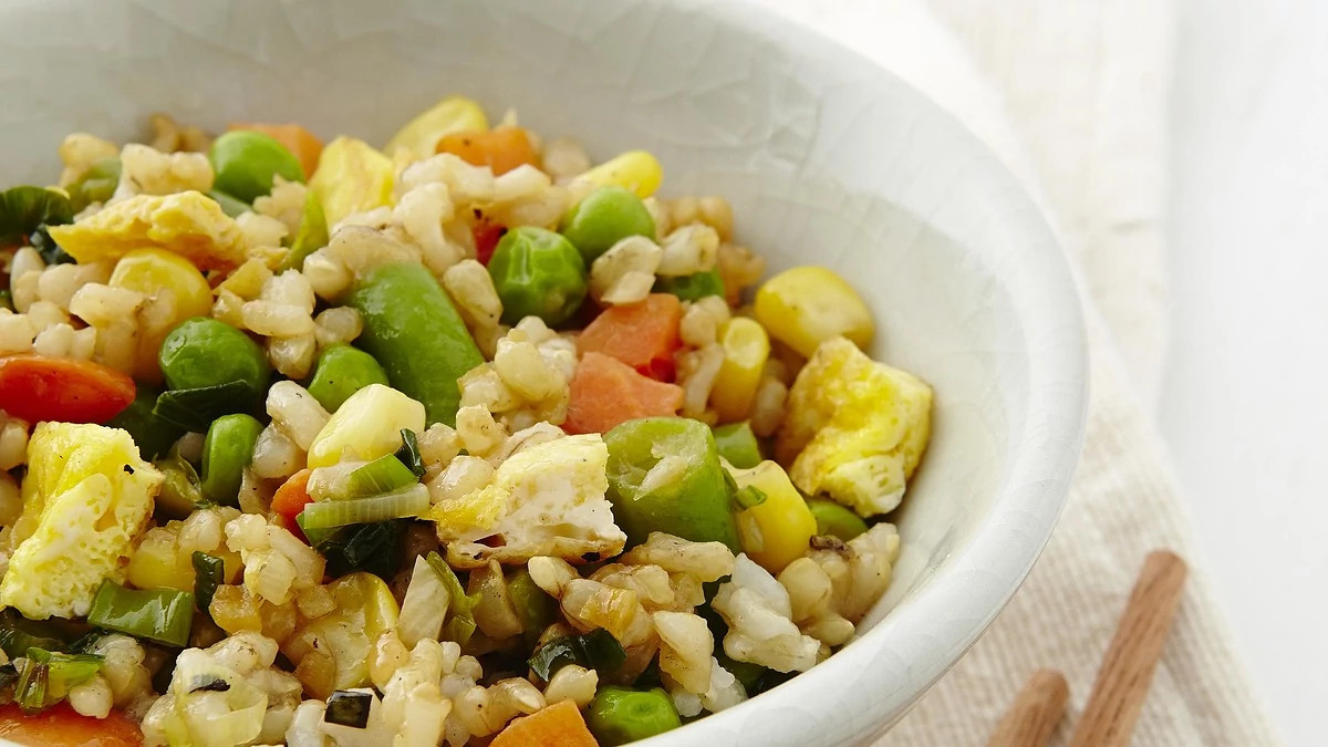 A close-up view of Cantonese chicken and bok choy fried rice in a bowl