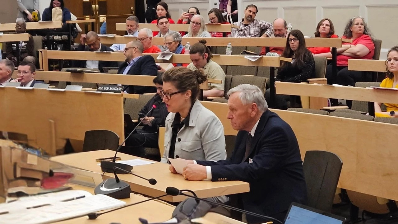 people testifying at a hearing
