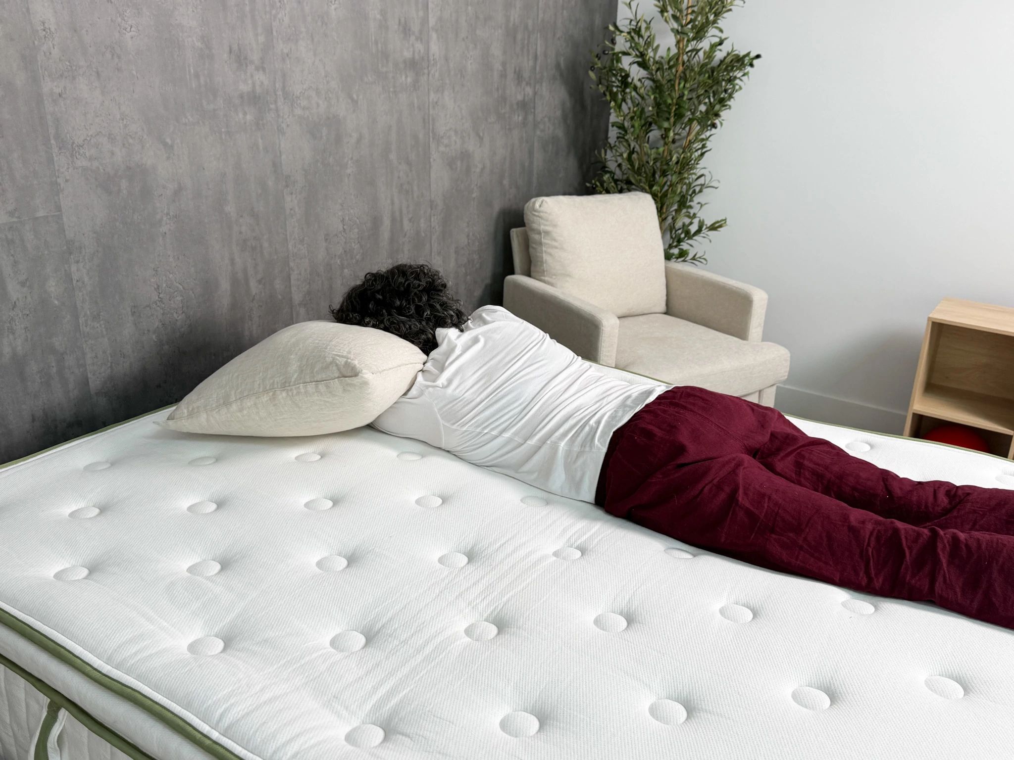 A person lying on their stomach on the Silk & Snow Organic mattress