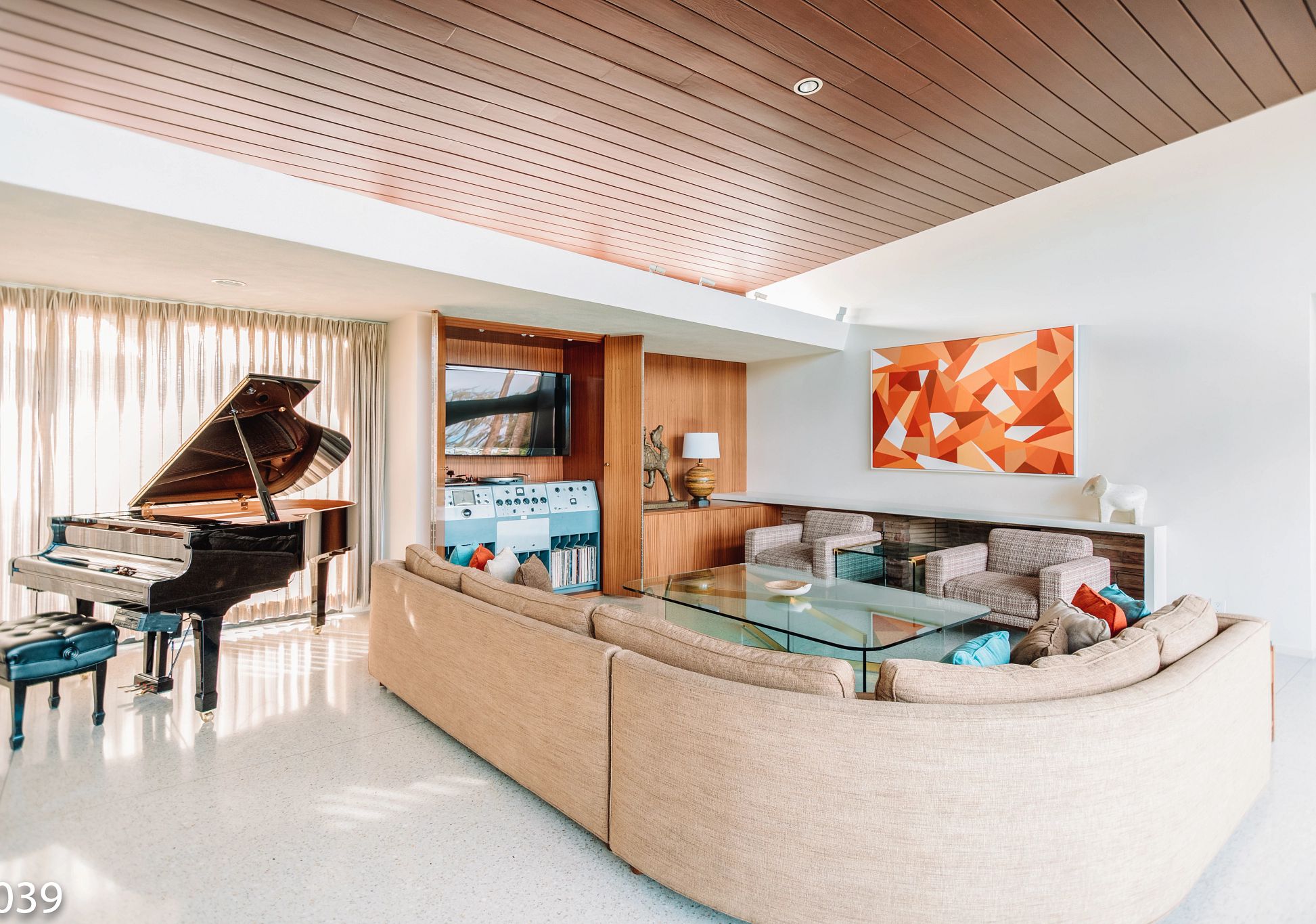 Frank Sinatra home a living room with a piano and mid-century decor