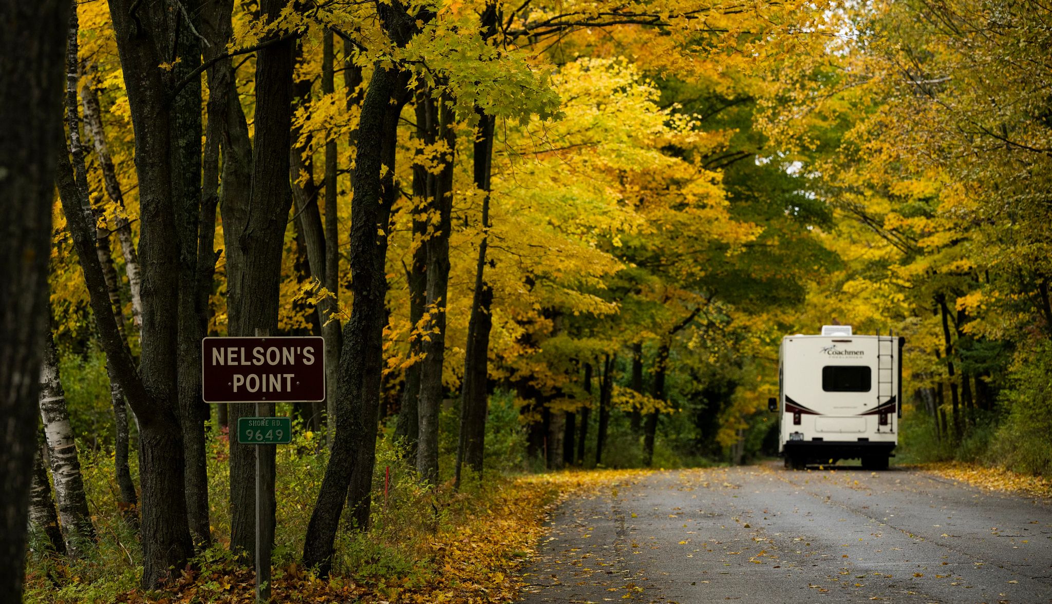 Campgrounds Near Scenic Drives a sign that reads nelson's point on the side of a road with an rv in the background