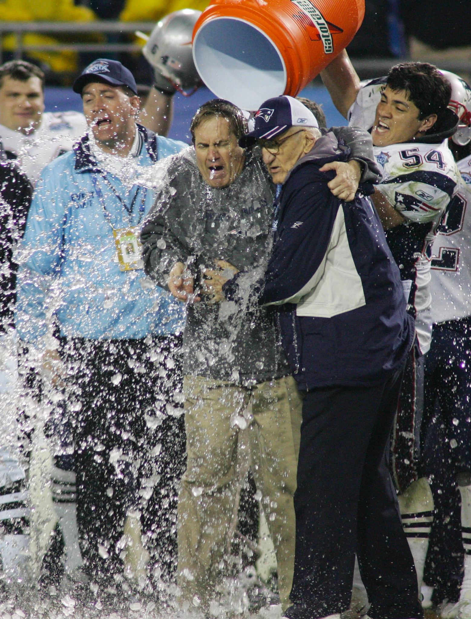 Tedy Bruschi (54) dumps water on head coach Bill Belichick