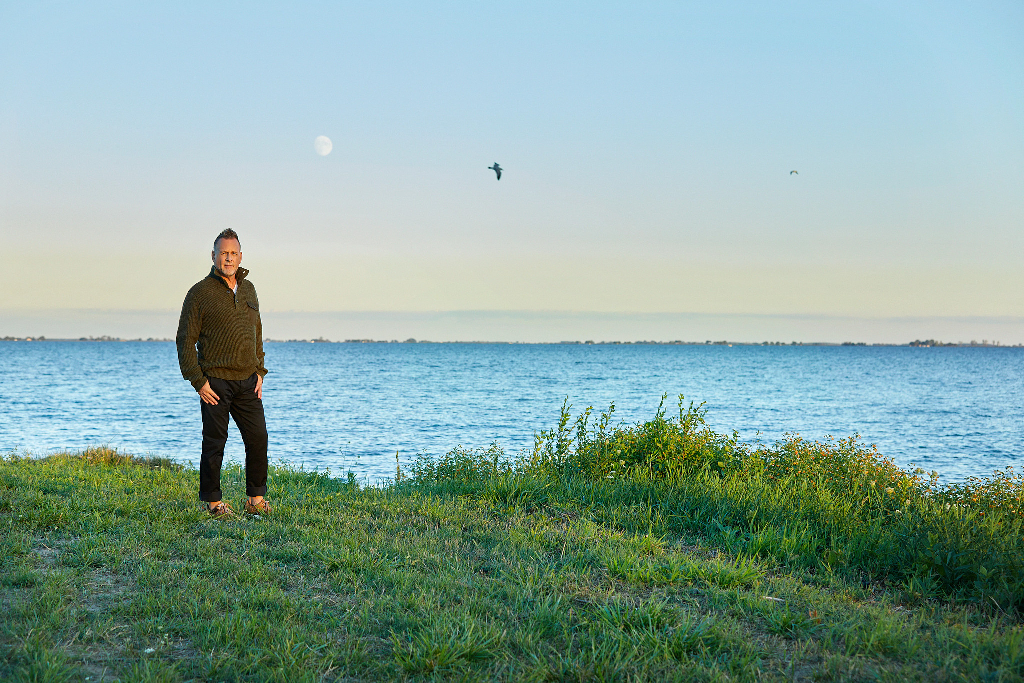 dave coulier posing for a portrait outdoors in front of water