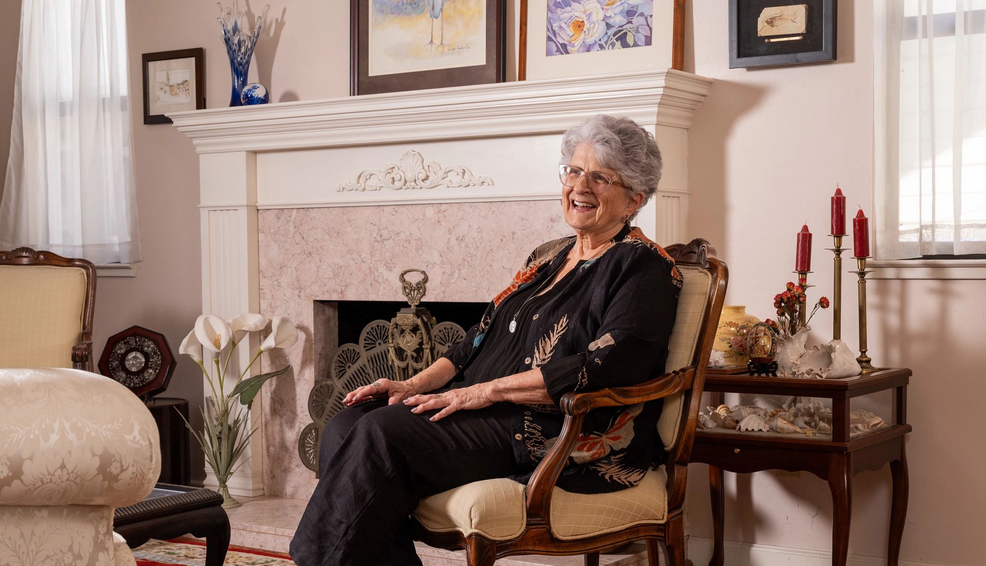 Transition Into Retirement a woman sits in a chair in front of a fireplace in her home