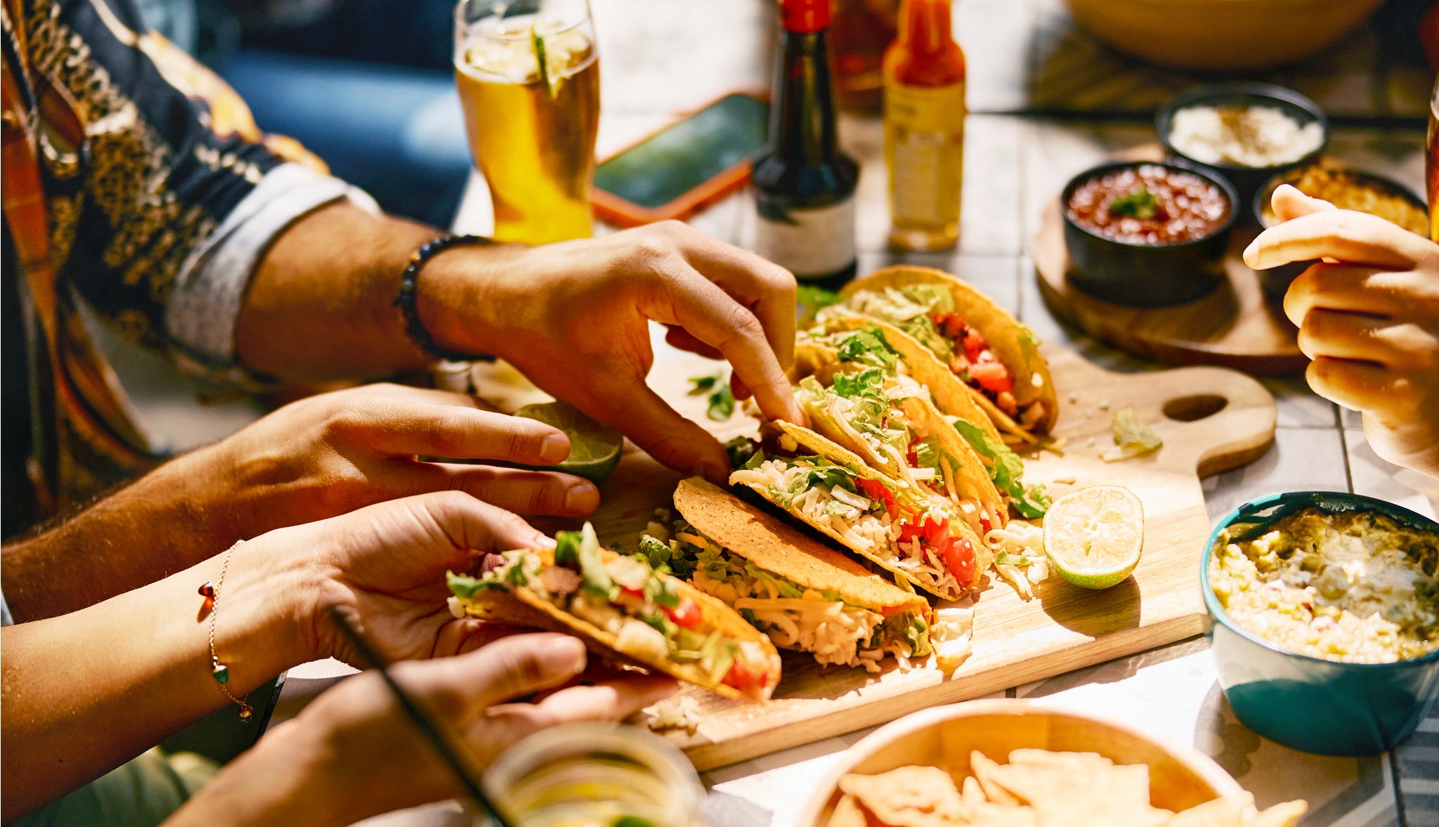 Cinco de Mayo Deals 2025 people eating tacos in a restaurant