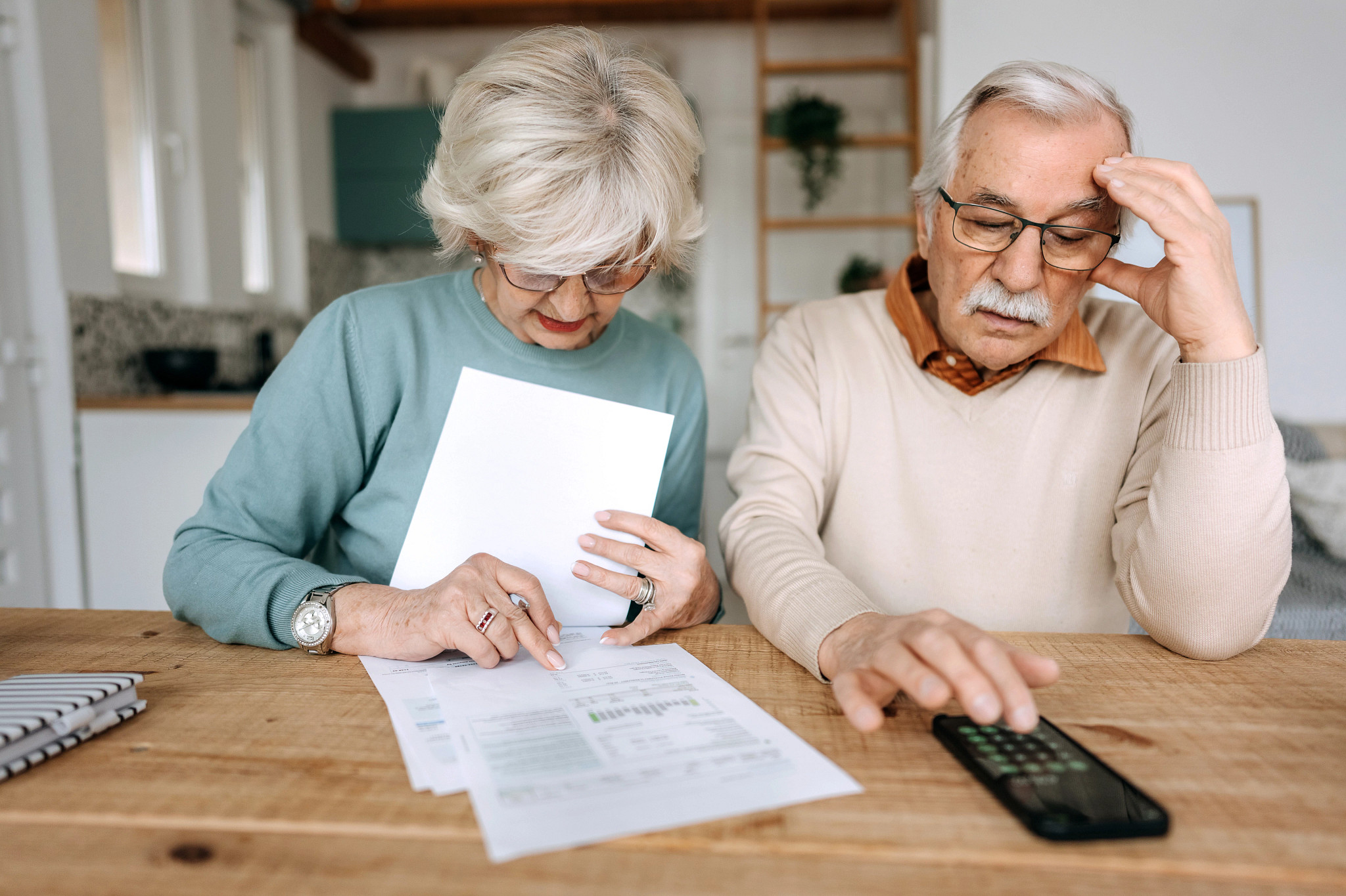 two people looking at bills