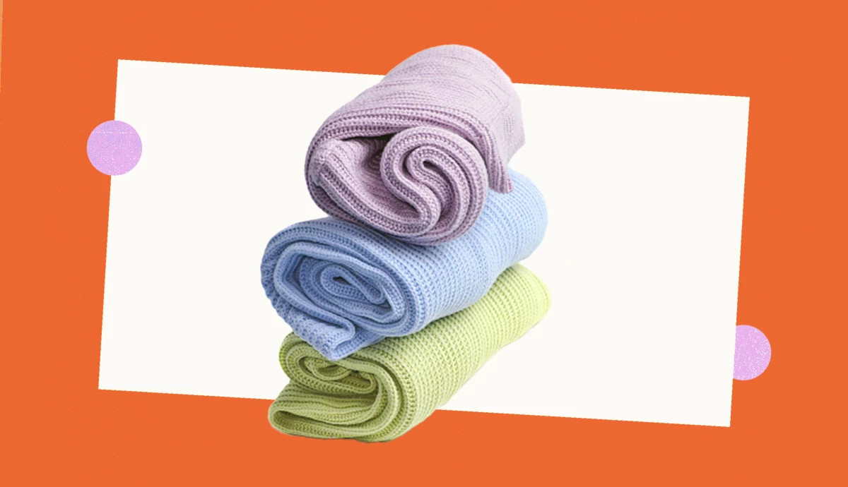 a stack of three folded sweaters in pastel colors on a background with orange, lavender and white shapes