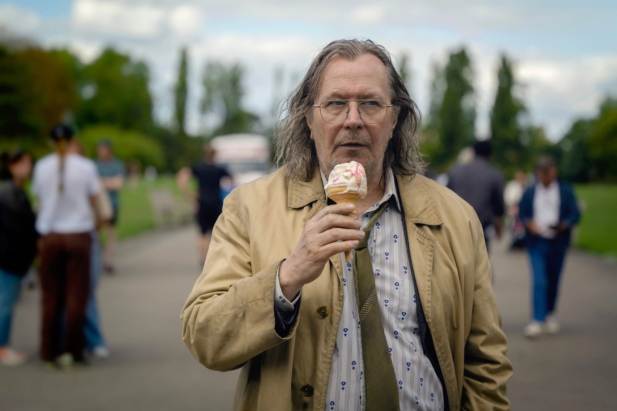 Gary Oldman eating an ice cream outside in the Apple TV plus series Slow Horses