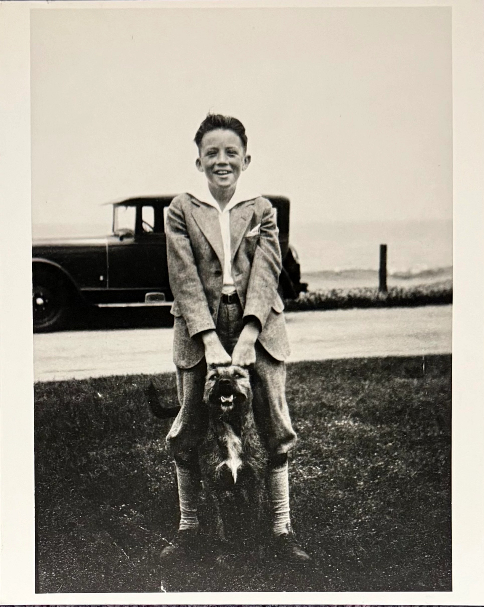 a photo shows a young Gregory Peck and his dog Bud in 1925