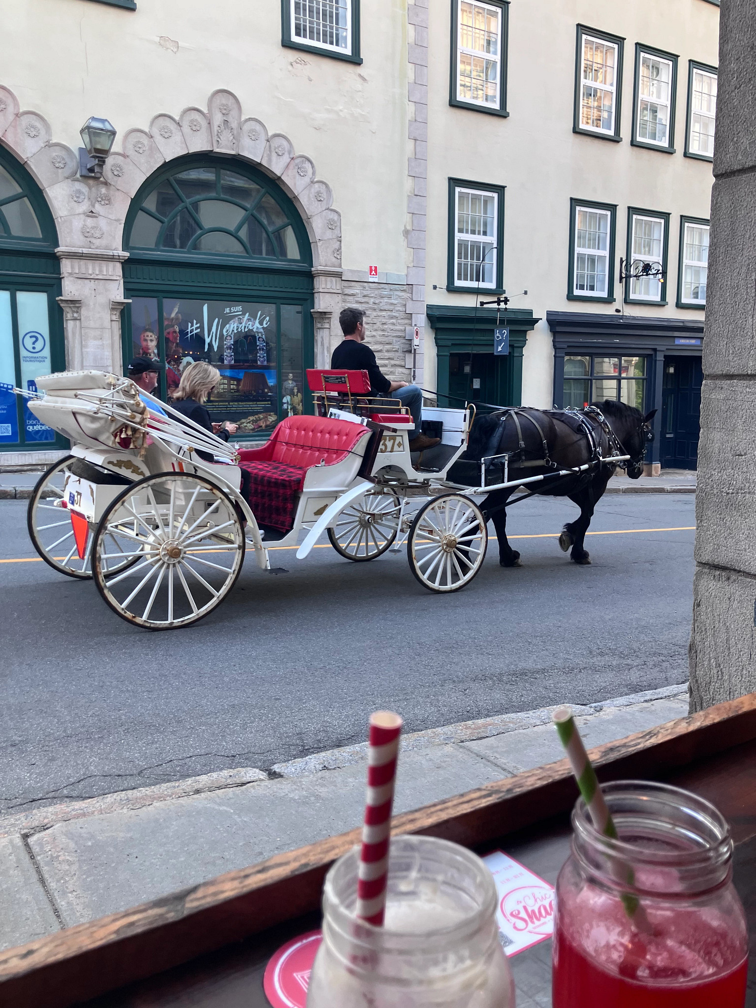 a horse drawn carriage on a street