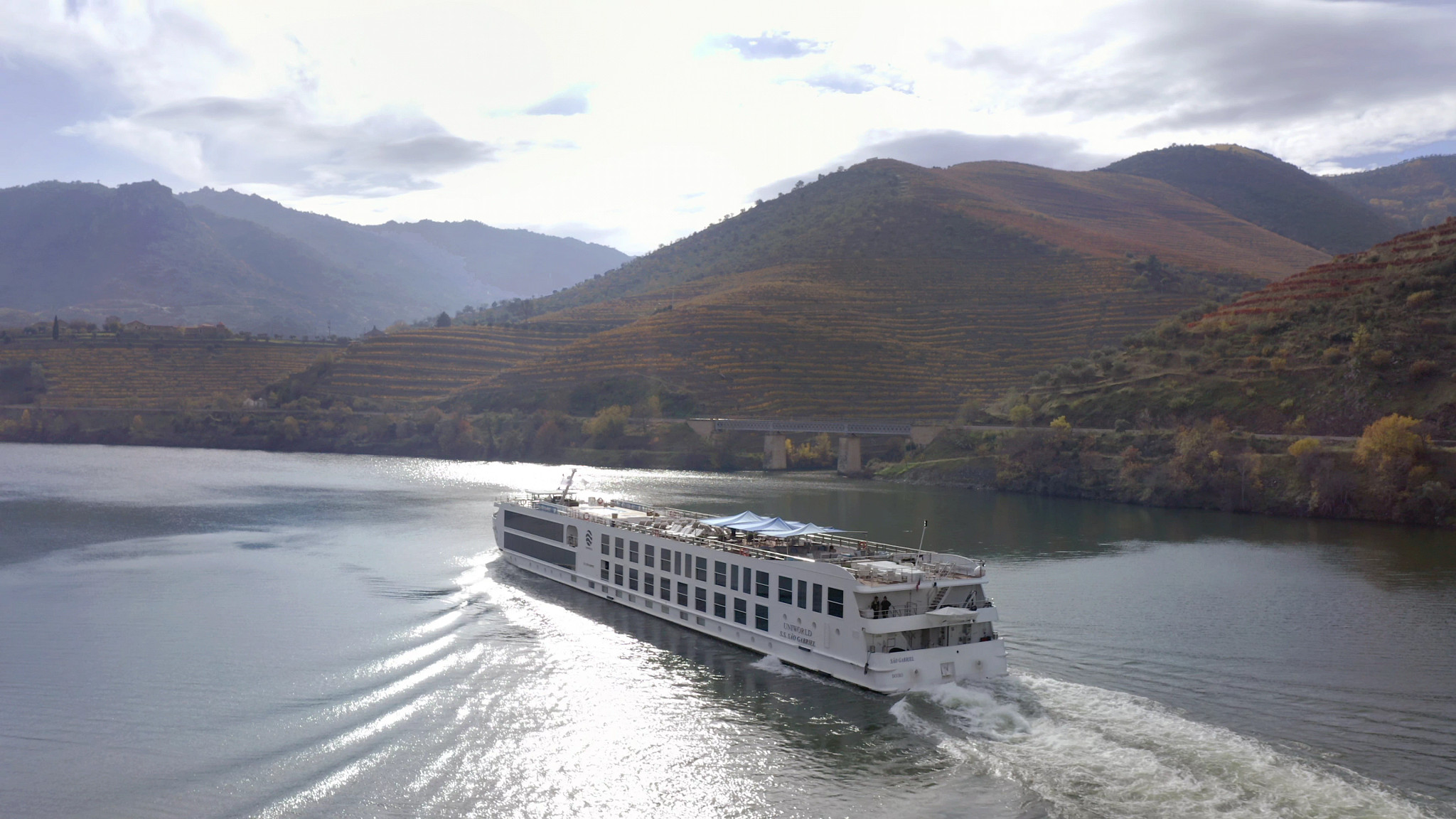 a river cruise ship traveling down the Douro River in Portugal
