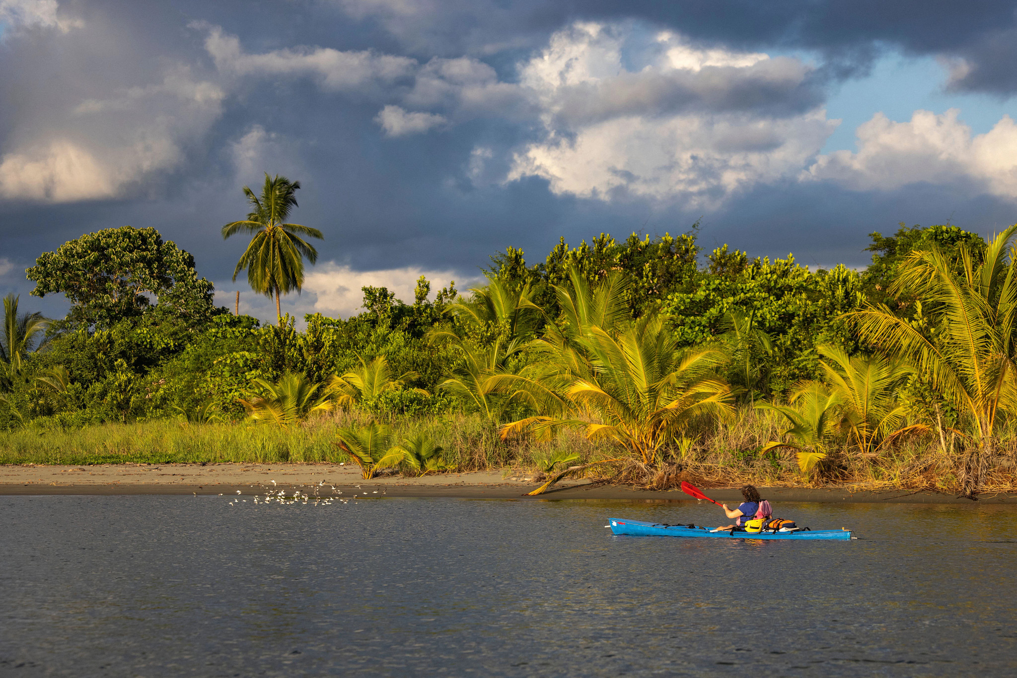 a kayaker off the shore of a beach in Costa Rica