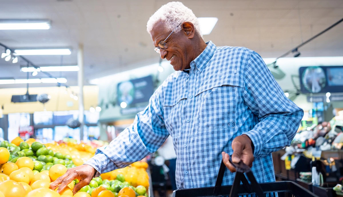 Man in produce aisle at grocery store