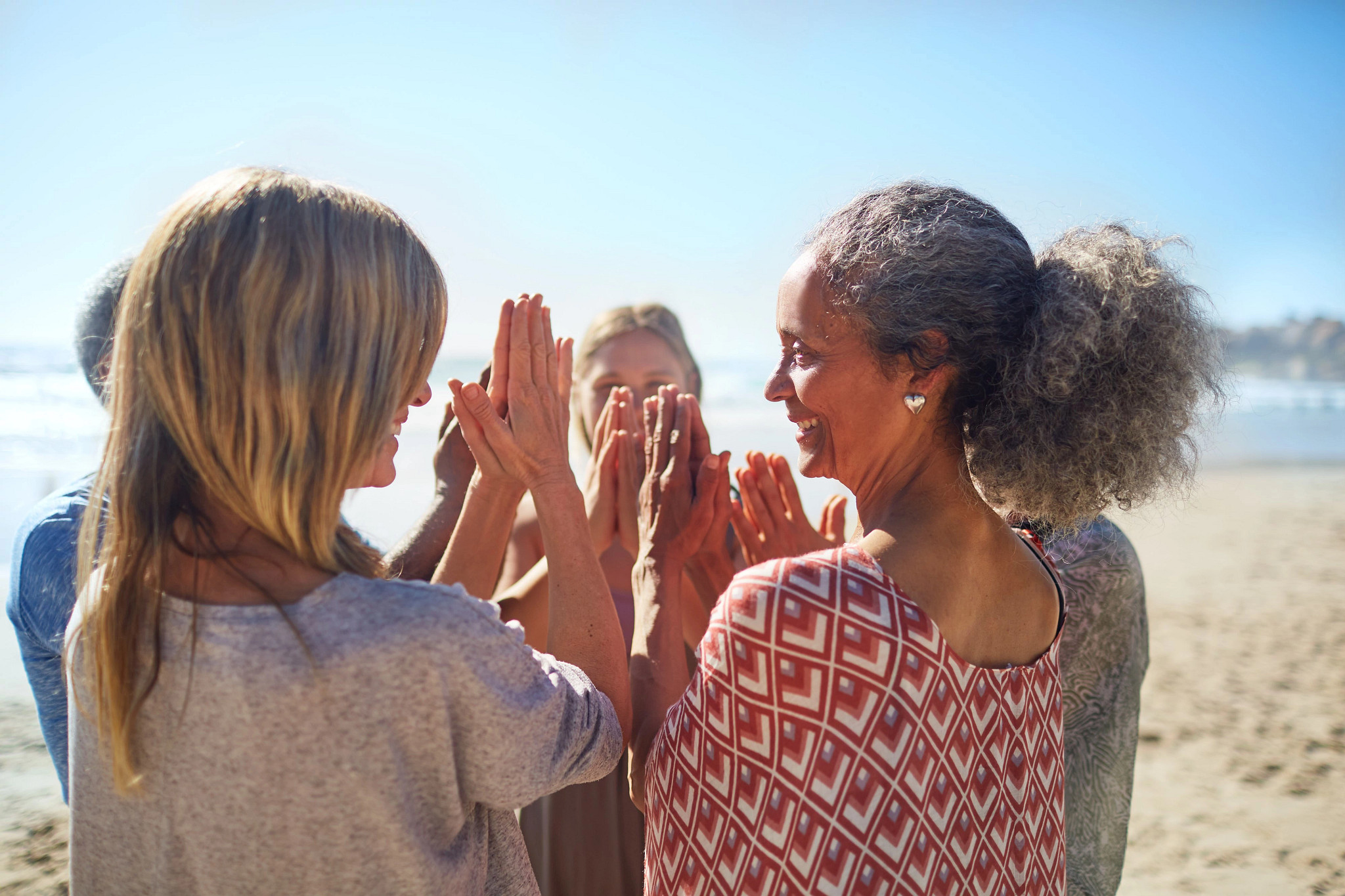 Picture of women smiling and standing in a circle